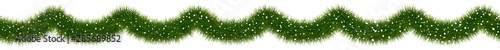 Festive Christmas fir garland covered with snow. photo