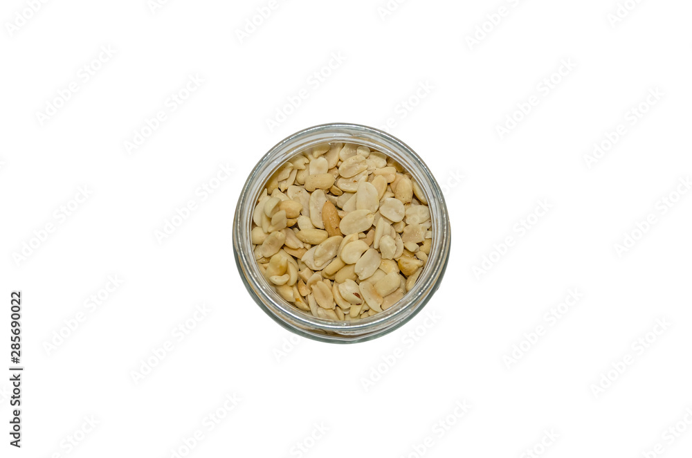 salted peanuts in a jar on a white background. salted peanuts in a jar on a white background.