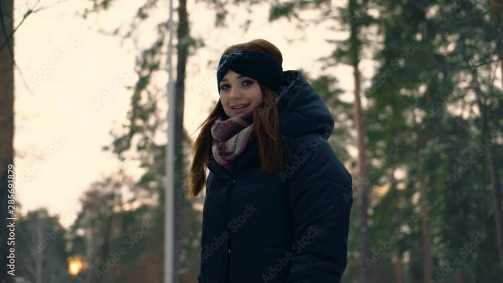 red ginger hair girl walks in a snowy park. Girl drinks coffee from a paper cup. winter evening 4K red ginger hair girl walks in a snowy park. Girl drinks coffee from a paper cup. winter evening 4K