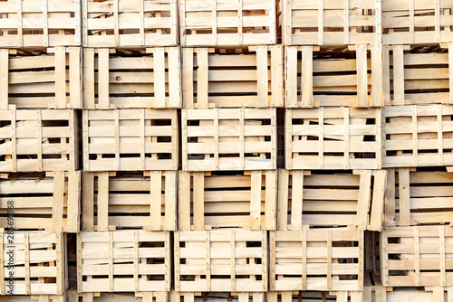 Bunch of empty wooden boxes stack at each other.