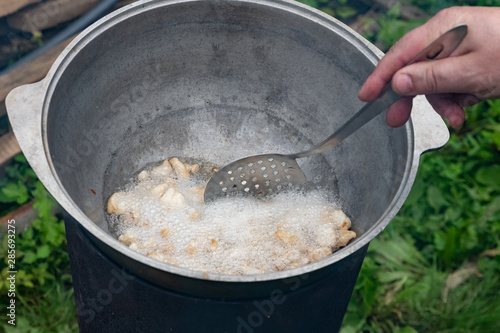 The process of cooking pilaf in a cauldron