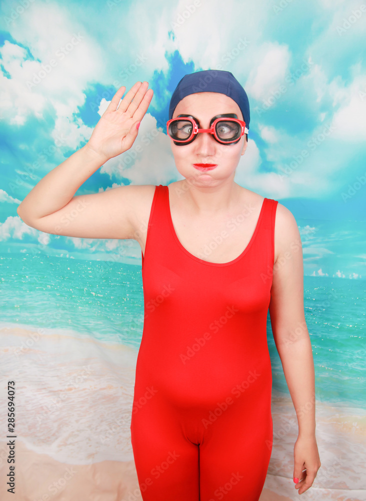 crazy diver in red swimsuit with swimming goggles on blue background.  person swimmer learn to swim. Stock Photo | Adobe Stock