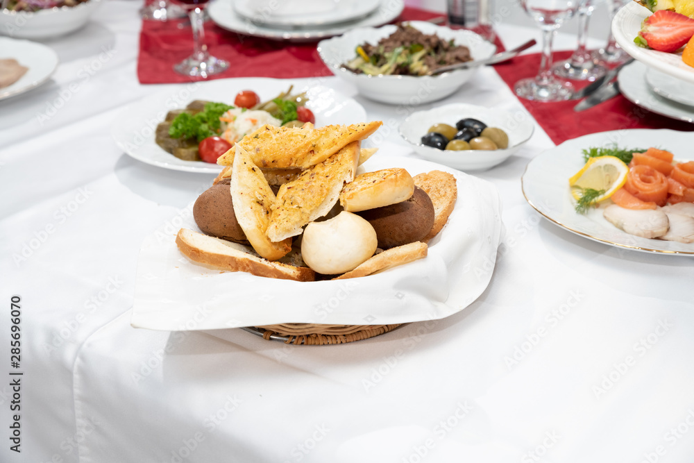 Setting stylish Ramadan,iftar dinner table with soup,chicken and rice,salad,dry and fresh fruits and Ramadan bread.