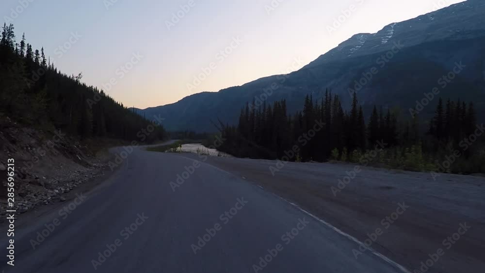 Driving alongside the Alaska highway during sunset next to river. Driving alongside the Alaska highway during sunset next to river.