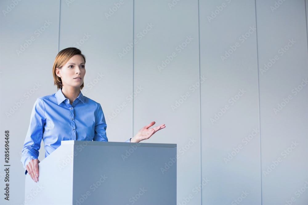 Young businesswoman discussing business plan with colleagues in office Young businesswoman discussing business plan with colleagues in office