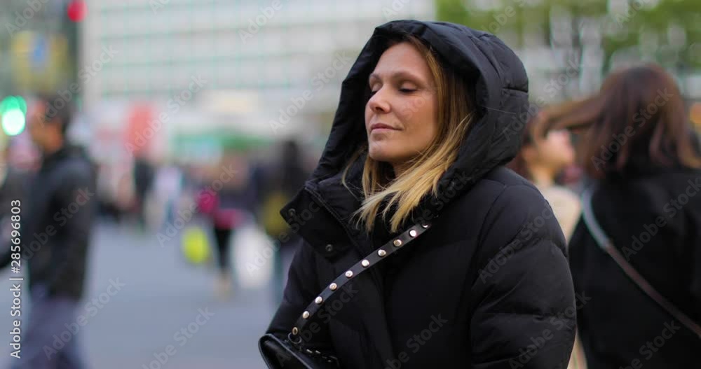 girl puts hood on a cold day in Tokyo girl puts hood on a cold day in Tokyo