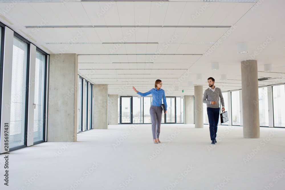 Business colleagues discussing interiors of new office Business colleagues discussing interiors of new office