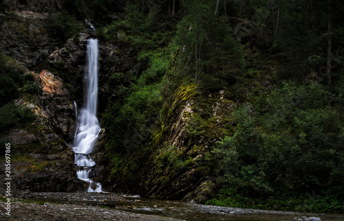 Waterfall in the wood near the town of Feichten, in the Kaunertal valley (Austrian alps) photo