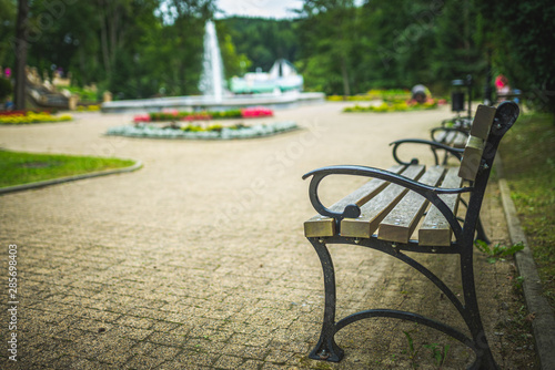 Bench in the park next to water fountain. © Przemyslaw Iciak