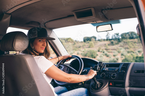 attractive blonde girl with cap driving