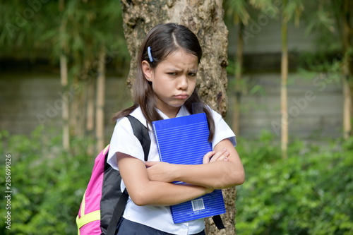 Stubborn Young Filipina School Girl With Notebooks