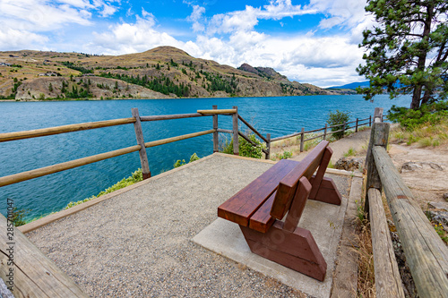 View of a park bench at Kalamalka Lake from Kalamalka Lake Provincial Park near Vernon British Columbia Canada photo