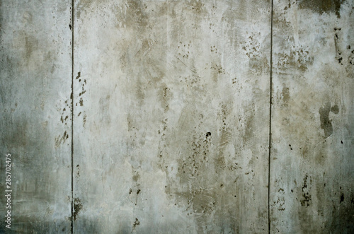 Grungy concrete gray wall with dark spots, surface is similar to moon surface, background for photo wallpaper