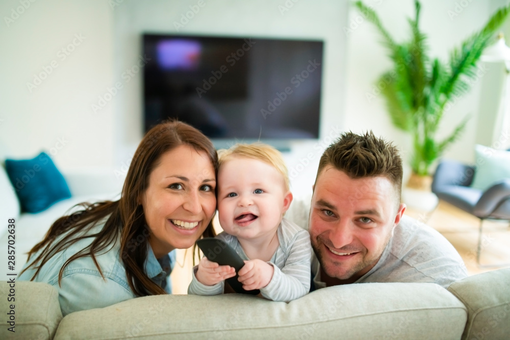Family watching television at home on the sofa Family watching television at home on the sofa
