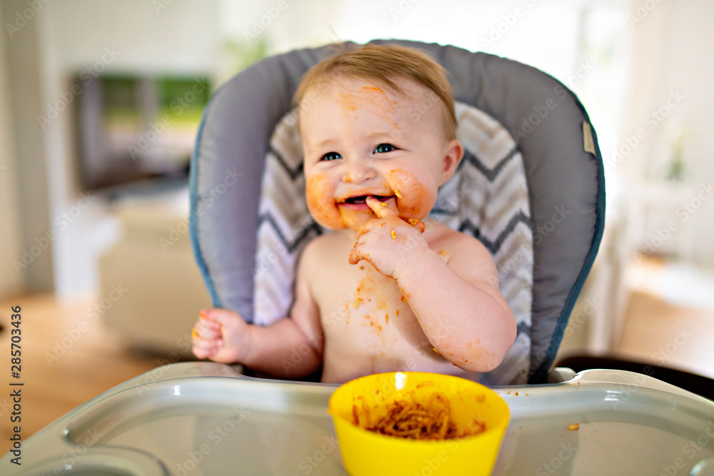 A Little baby eating her dinner and making a mess A Little baby eating her dinner and making a mess