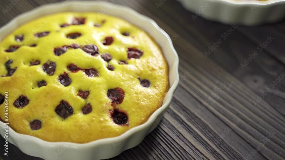 Berry biscuit mini tarts in a baking dish. Tasty dessert with currants. Dark wooden background. Tilt Down Close Up Berry biscuit mini tarts in a baking dish. Tasty dessert with currants. Dark wooden background. Tilt Down Close Up
