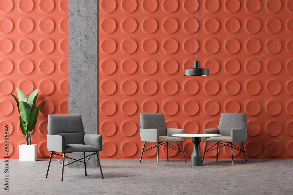 Orange office lounge with armchairs and tables
