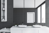 Double sink in gray tile bathroom interior