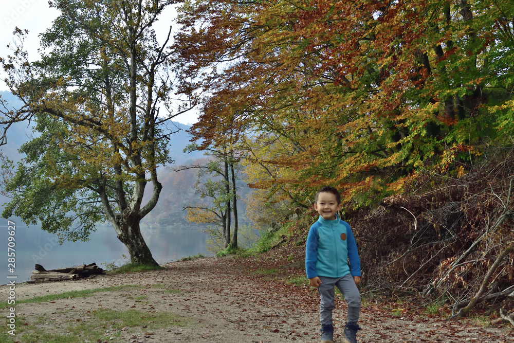 Cute boy traveling in Plitvice National Park, Croatia, in the fall Cute boy traveling in Plitvice National Park, Croatia, in the fall