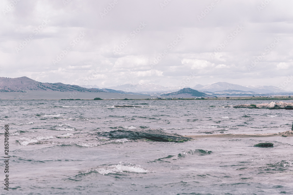 Blue ocean waves on the bay with seagulls 