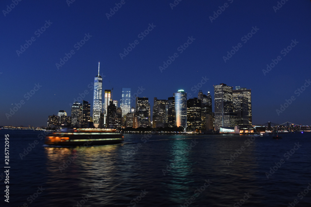 Cityscape By River Against Clear Sky