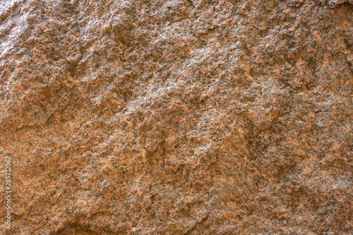 The structure of red and black granite. The texture of natural stone. Creative vintage background.