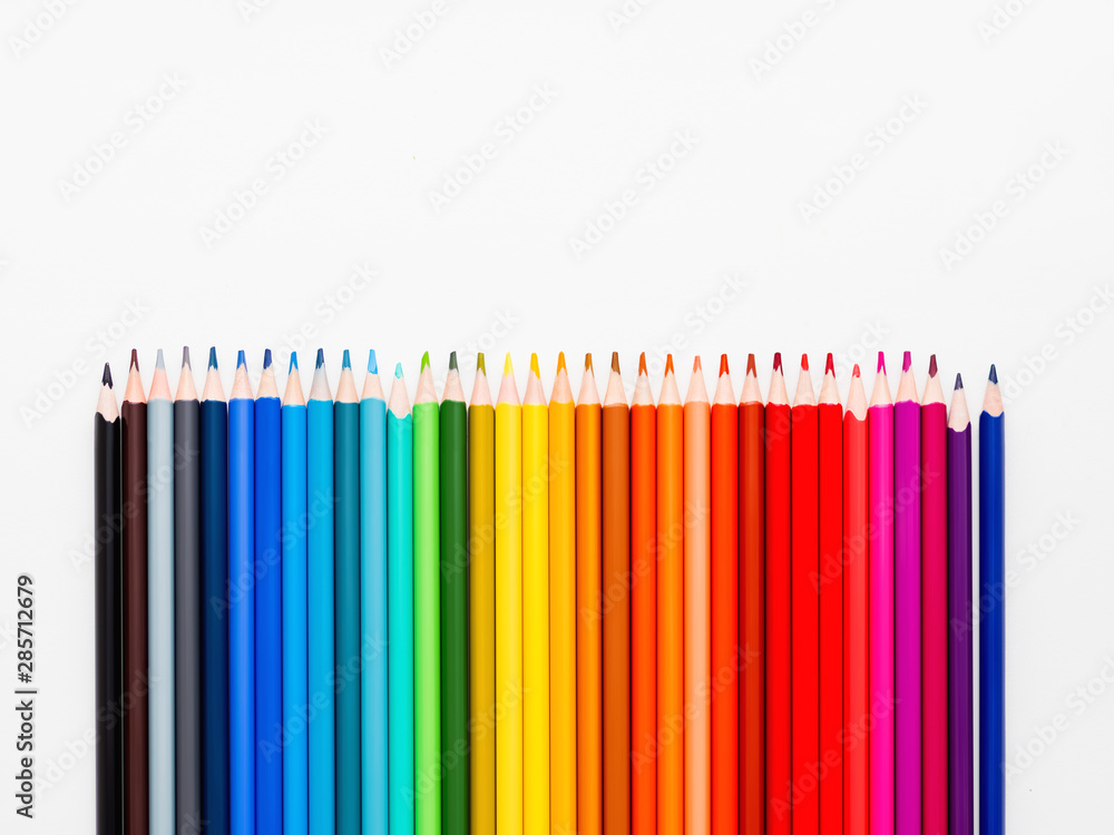 Vertical row of colorful pencils on white background. School supplies in colores of rainbow. Kid's stationery with copy space. Back to school backdrop. Vertical row of colorful pencils on white background. School supplies in colores of rainbow. Kid's stationery with copy space. Back to school backdrop.