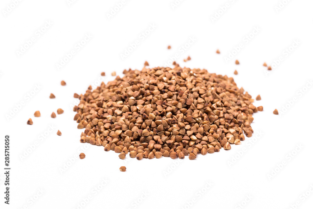 Pile of buckwheat isolated on white background. Top view. Pile of buckwheat isolated on white background. Top view.