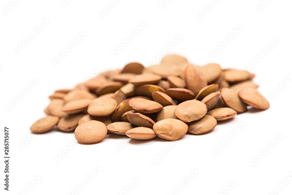 Isolated stack of uncooked lentils on white background from above. Isolated stack of uncooked lentils on white background from above.