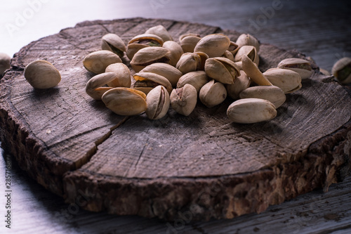 still life of isolated pistachios in the foreground in studio. photo