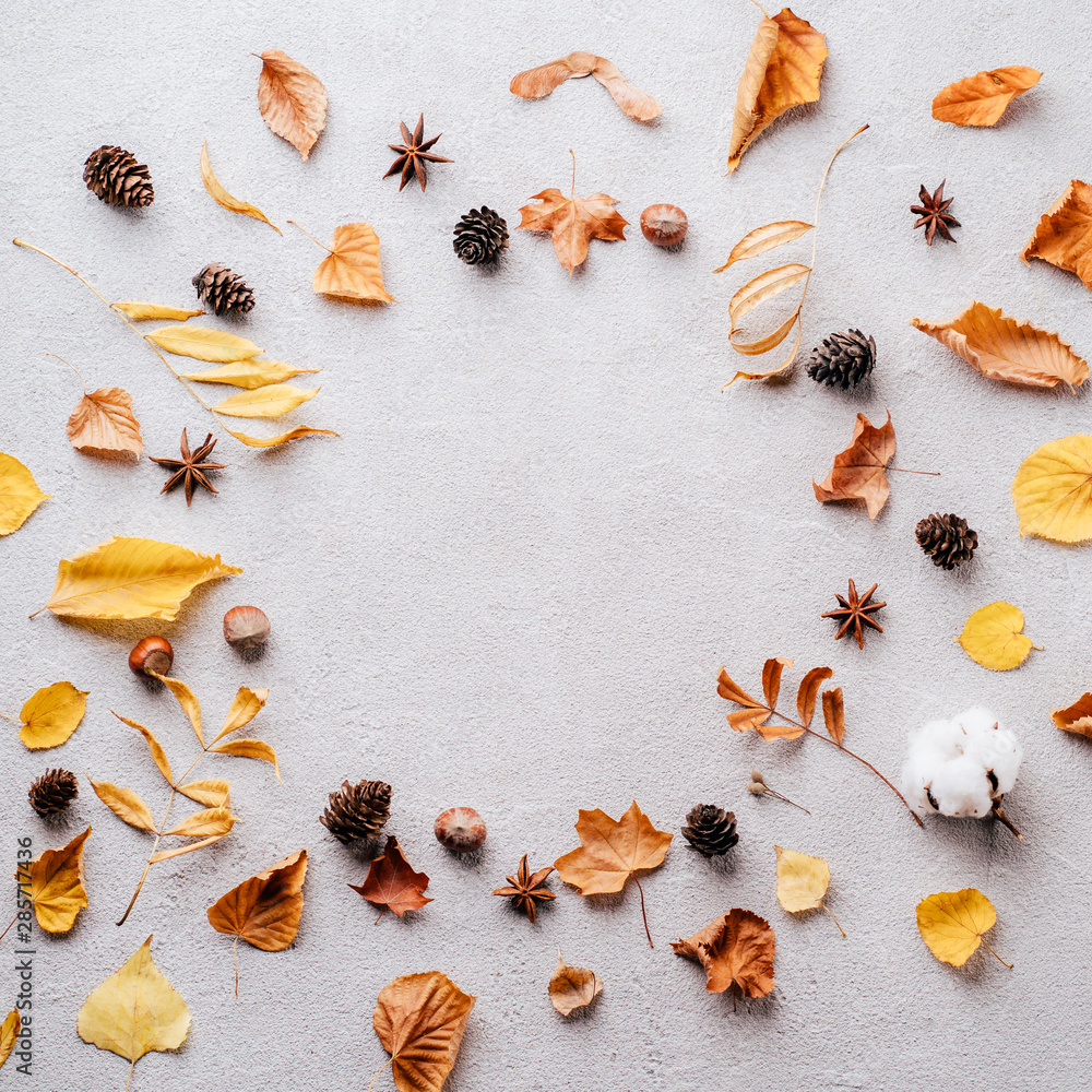 Autumn or winter composition. Dried leaves, spices, pine cones on stone background. Fall, thanksgiving day concept. Flat lay, top view, copy space