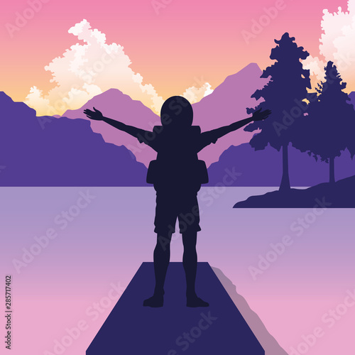 Backpack Traveler with arms up at nature