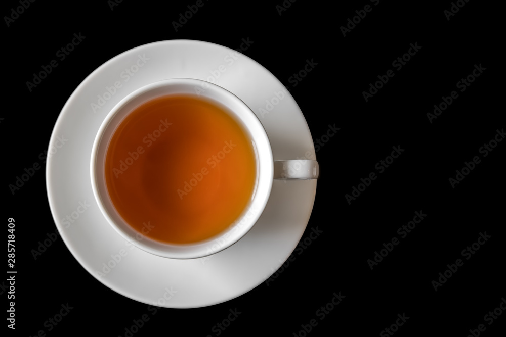 Filled Cup of tea on black background.