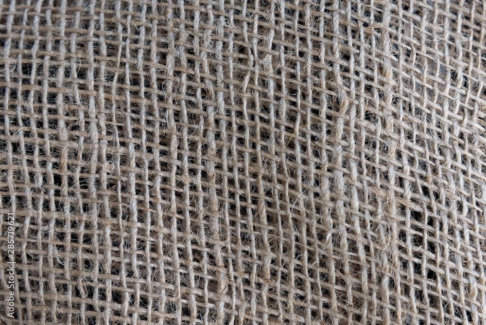 A focus of calico fabric texture, natural brown cool background A focus of calico fabric texture, natural brown cool background