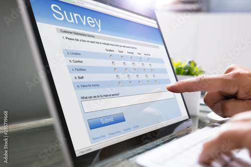 Man Giving Online Survey On Laptop photo