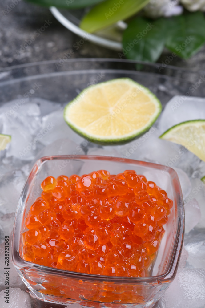 fresh red salmon caviar with lime around ice. macro shot. Protein luxury delicacy healthy food fresh red salmon caviar with lime around ice. macro shot. Protein luxury delicacy healthy food