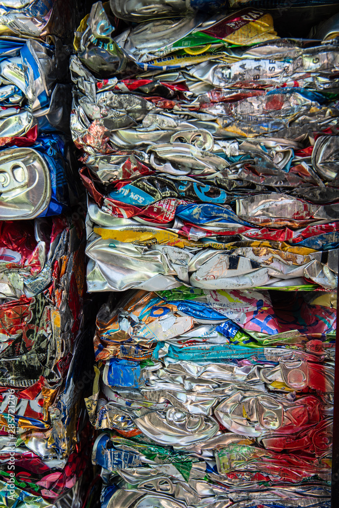 cubes or blocks of crushed aluminum cans stacked at recycling center