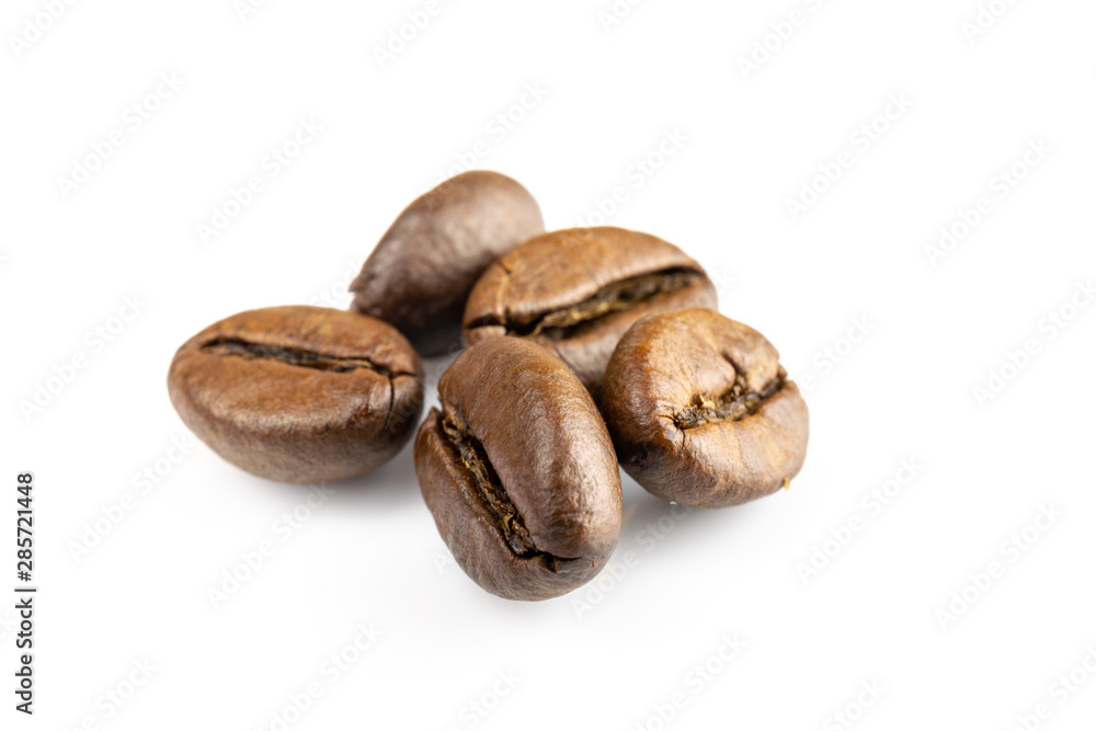 Roasted coffee beans isolated in white background cutout. Coffee background or texture concept. Roasted coffee beans isolated in white background cutout. Coffee background or texture concept.