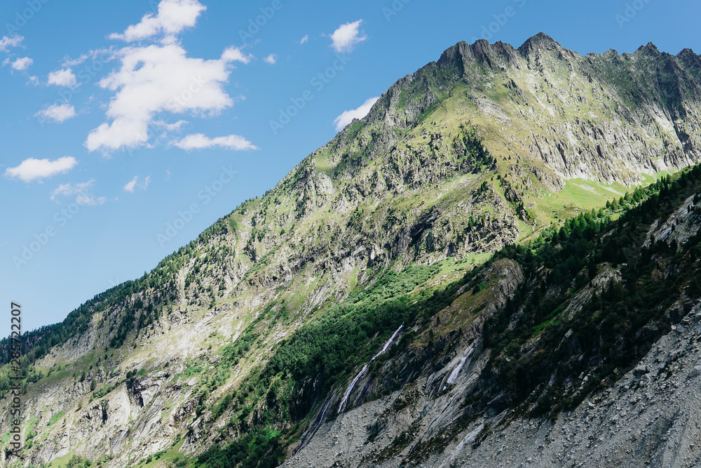 Scenic Alps mountain panorama. Journey Travel Trek and real life concept. Tourism idea with copy space. Beautiful nature. Rest in the mountains. Autumn in Alps in green and white colors