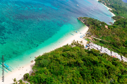 Aerial view from the drone on the landscape tropical island with turquoise sea with boats, palm trees and hotels. Summer vacation concept.