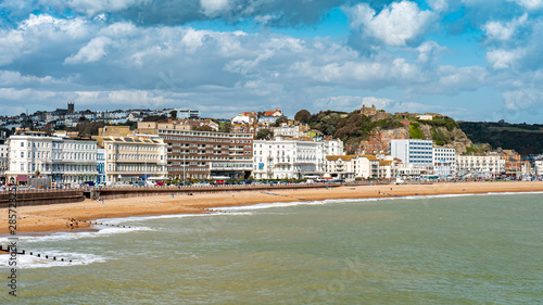Hastings Castle and seafront, England. The seafront to the East Sussex town of Hastings with its landmark castle visible on top of the hill. photo