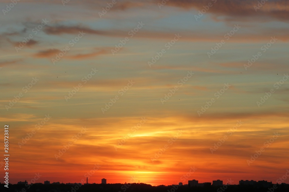 Beautiful orange golden sunset background over the city