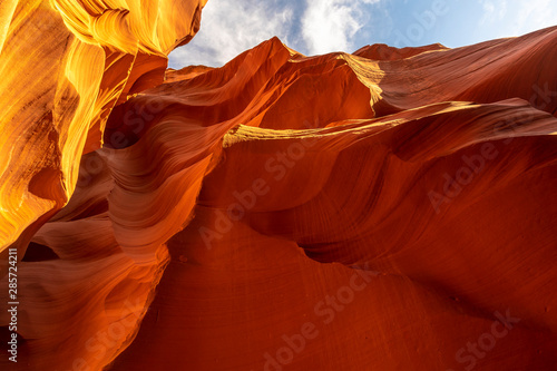 Mix of beautiful orange and red textures in Lower Antelope and the blue sky above in Arizona. United States