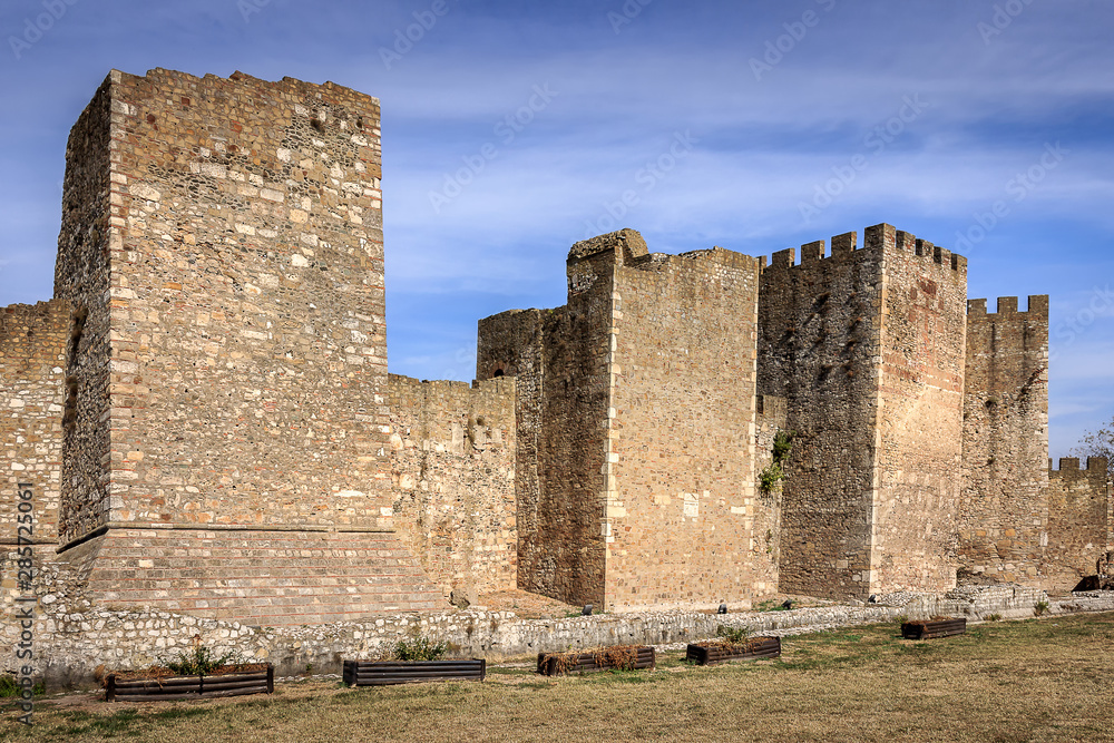 Naklejka premium Ancient Smederevo fortress stone walls and smooth clouds on a blue sky