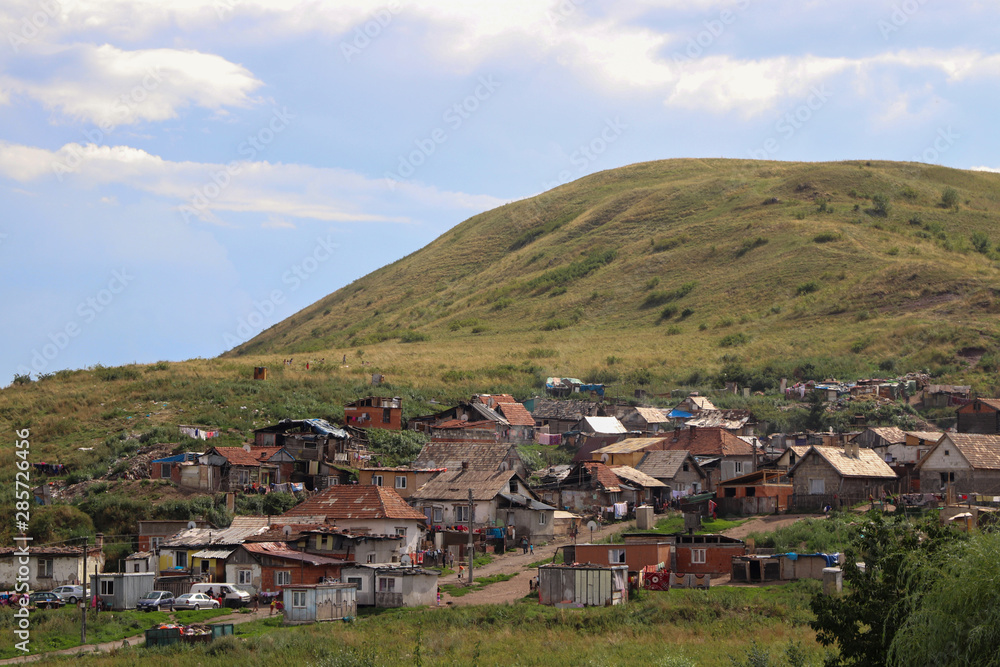 Gypsy village on eastern Slovakia. Natural living. Typical gypsy settlement under the hills.