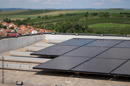 Solar panels at the top of the building. Solar modules on a flat roof.