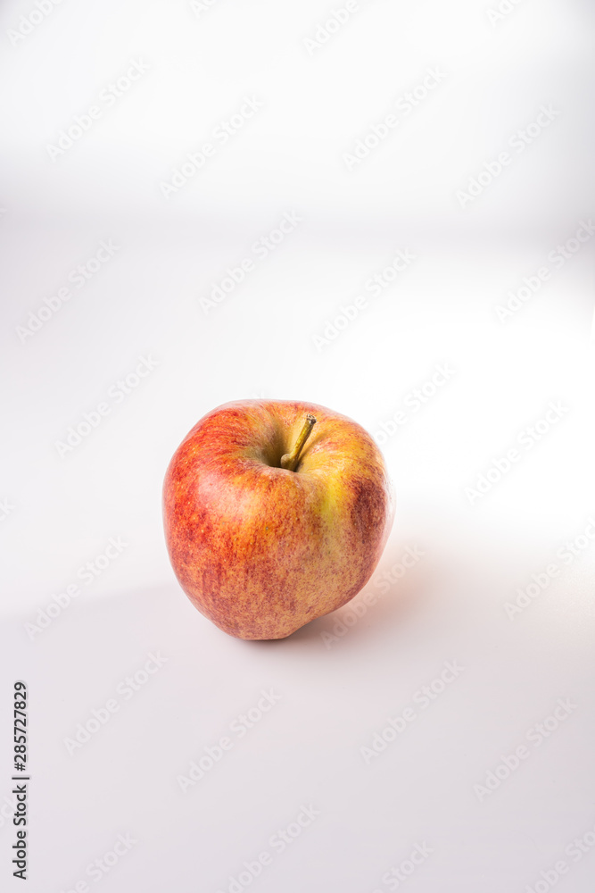 Red and orange Fuji apple isolated against a white background Red and orange Fuji apple isolated against a white background