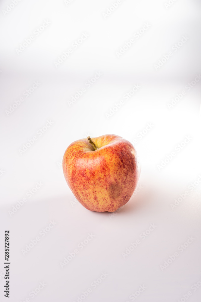Red and orange Fuji apple isolated against a white background Red and orange Fuji apple isolated against a white background