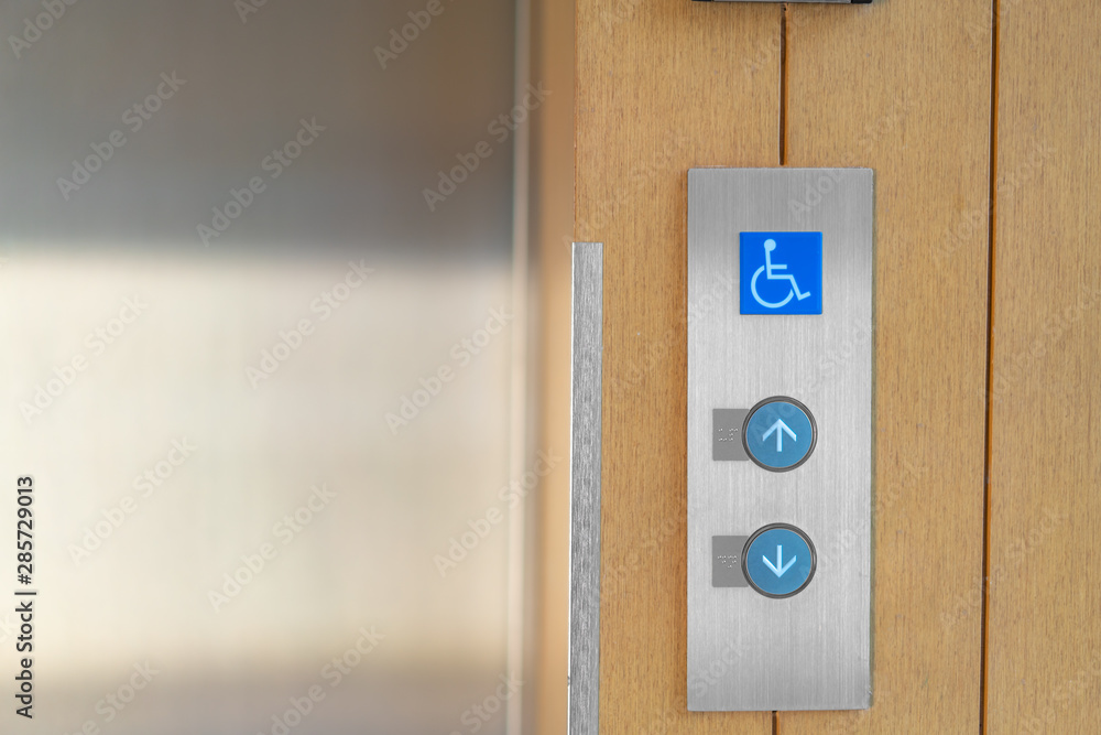 Elevator buttons with Braille codes and handicap sign. Allow signs for ...