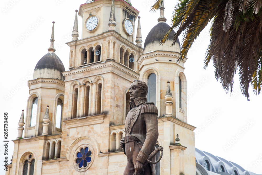 Fototapeta premium Monument to Simon Bolivar and the Parish Church of the small town of Ventaquemada in Colombia